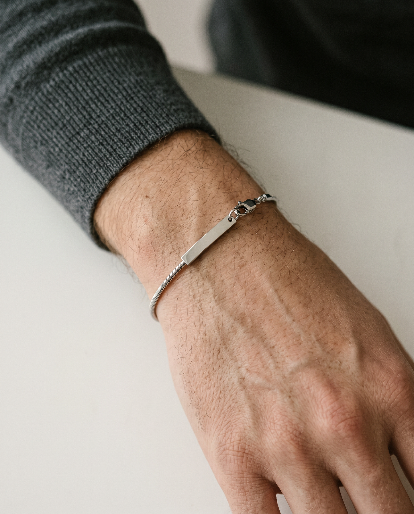Silver chain bracelet worn on the wrist