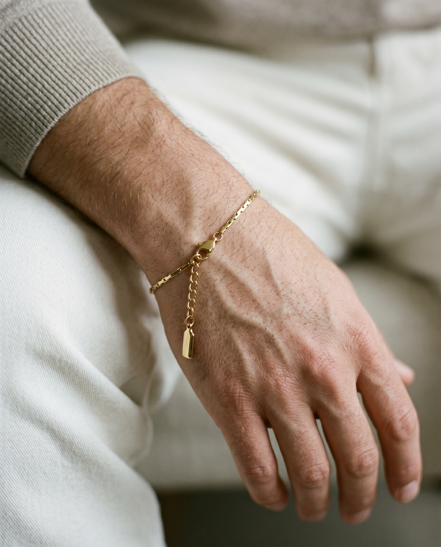 Fine gold chain bracelet worn on the wrist
