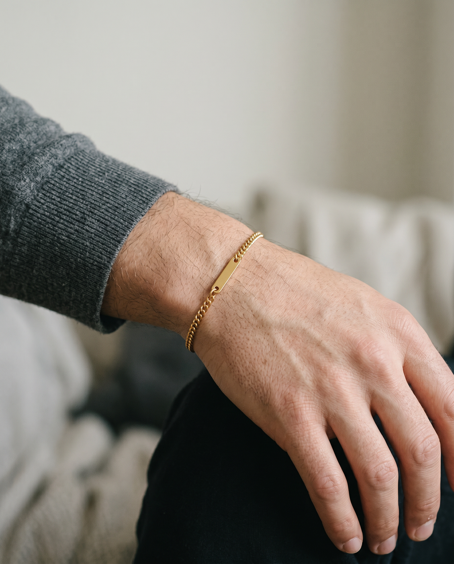 Gold Cuban link bracelet worn on the wrist