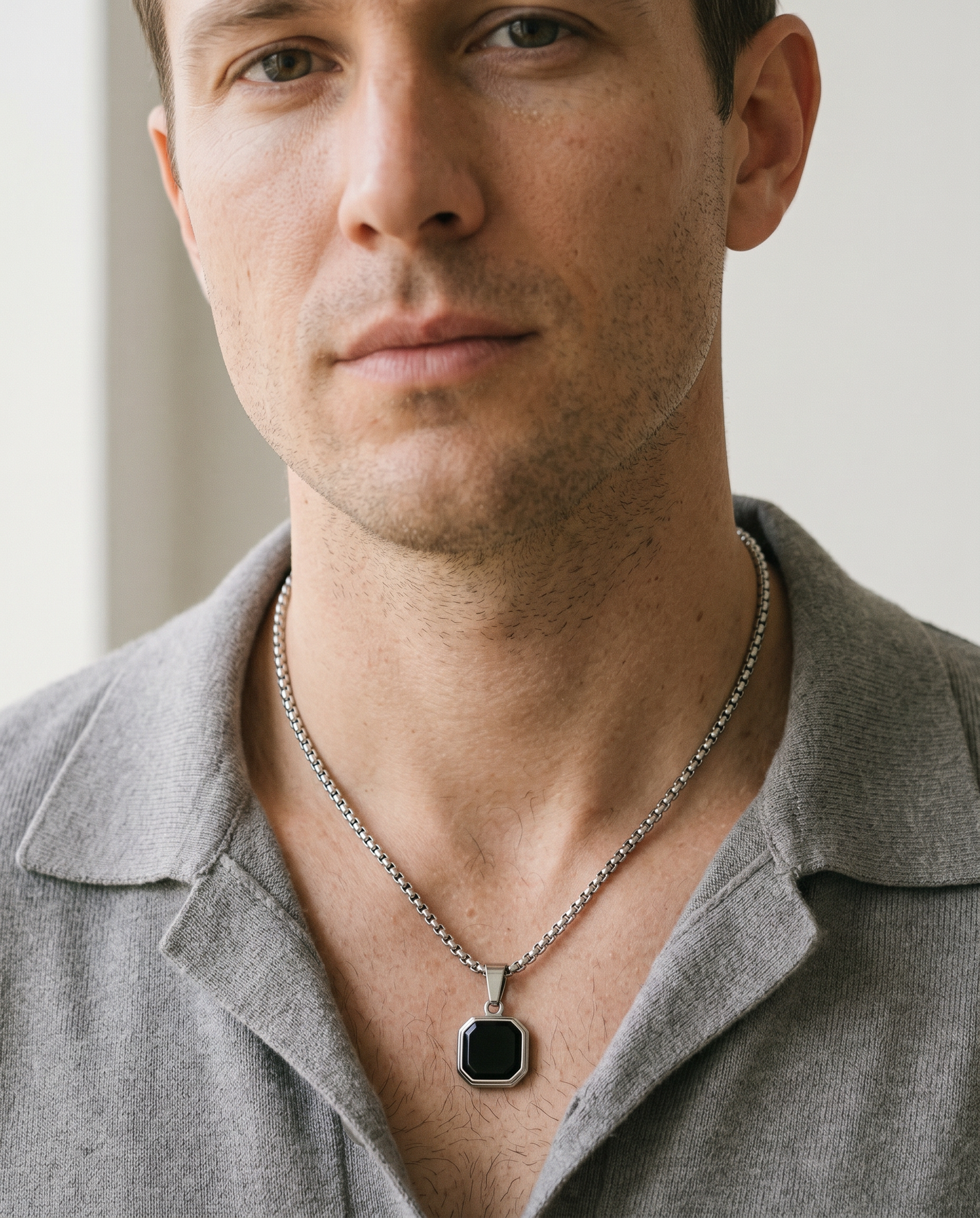 Man wearing the onyx octagon pendant