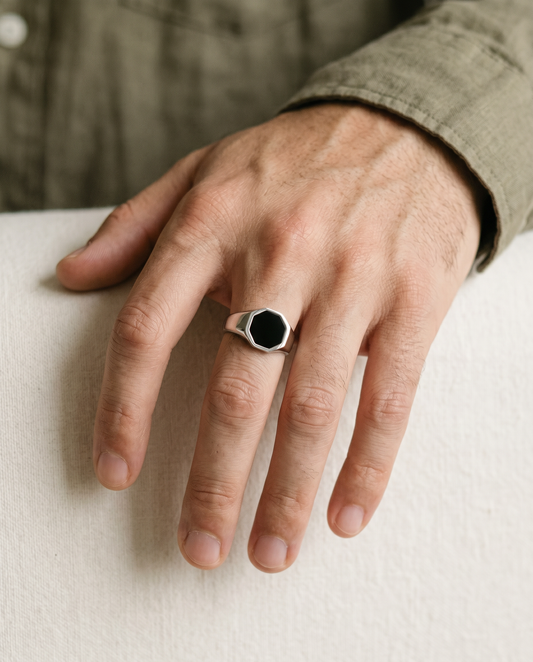Hexagon onyx signet ring worn on the hand