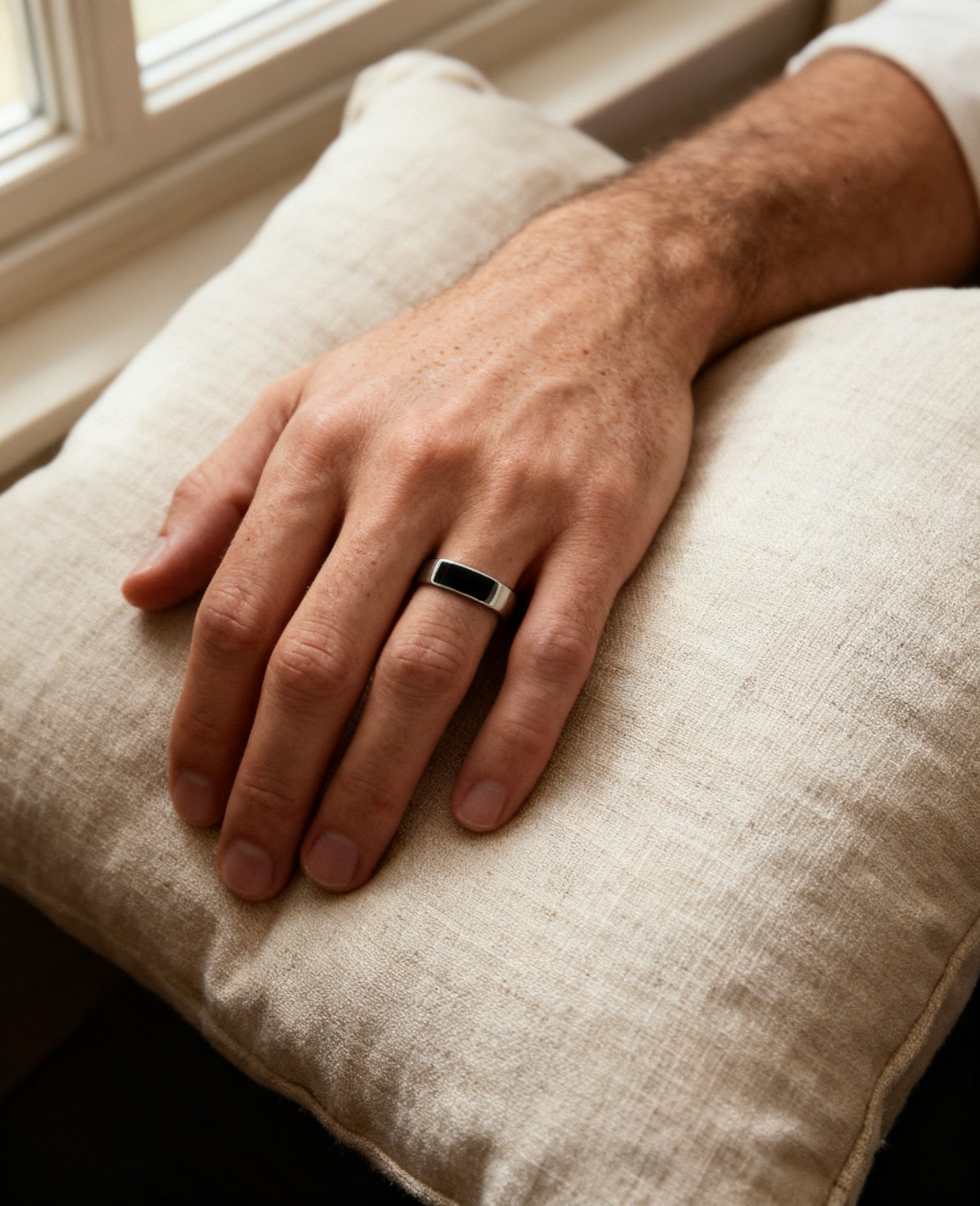 Bar onyx signet ring worn on the hand