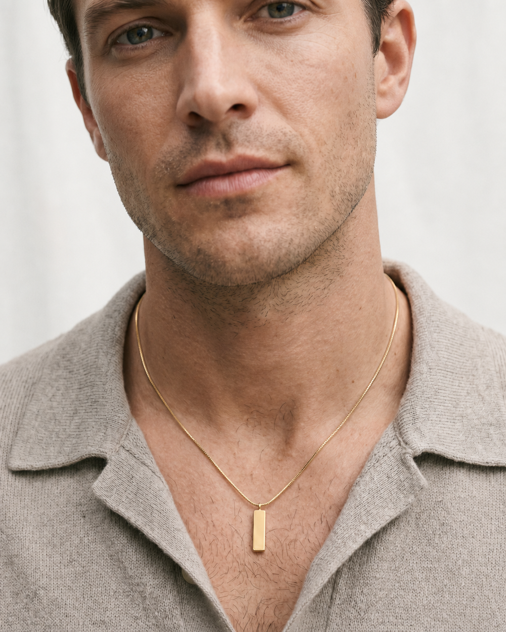 Man wearing the gold bar pendant necklace