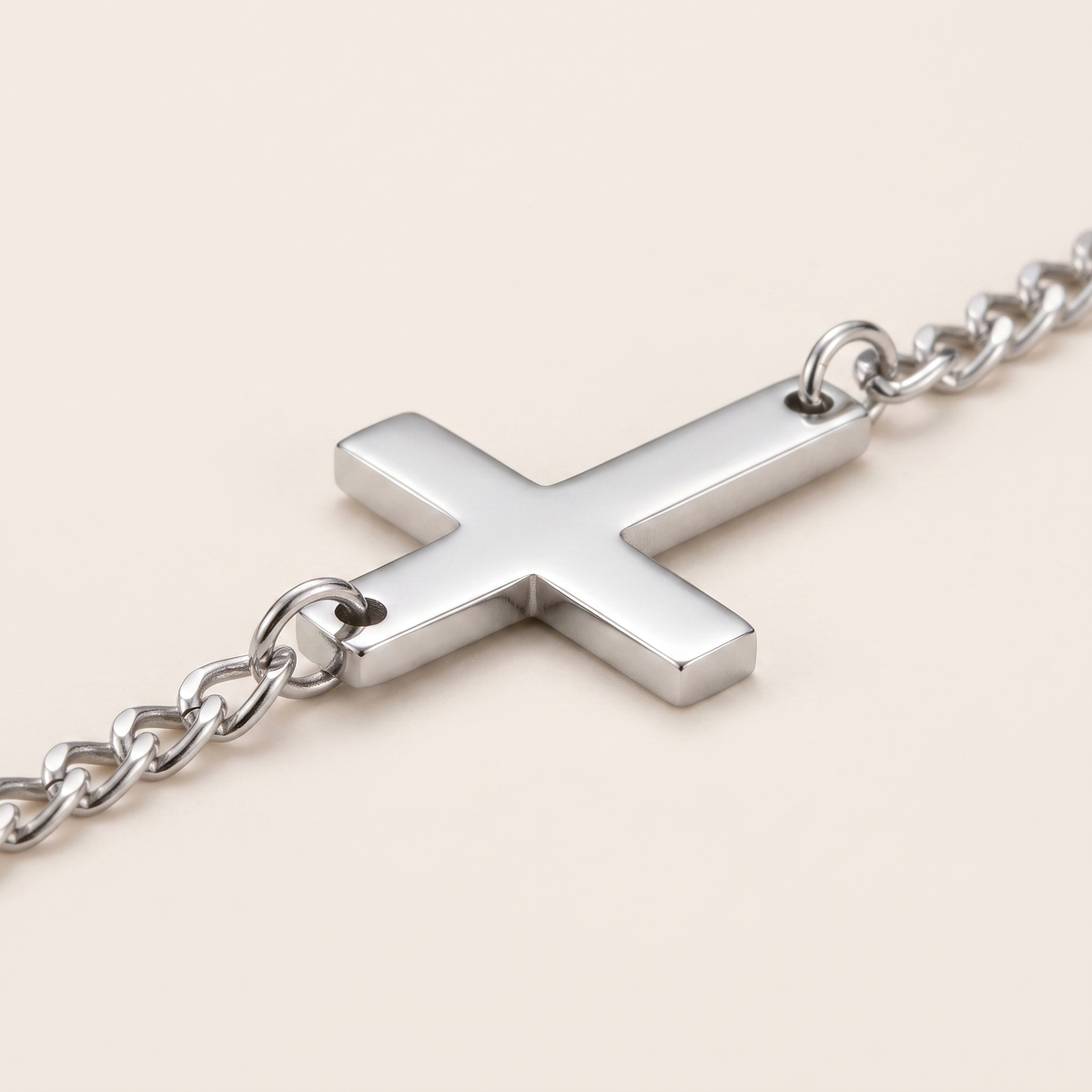 Close up of the cross and curb chain on the Cross Bracelet