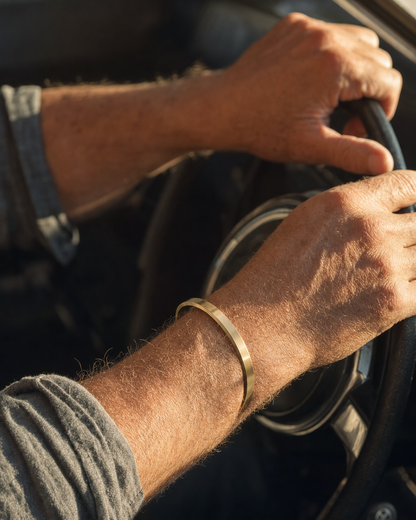Gold Meridian Cuff worn while driving