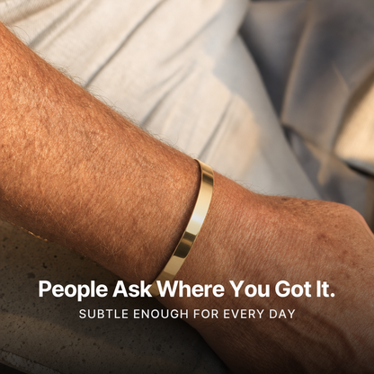 887Seven Meridian Cuff in 18K gold worn on a man's wrist on a concrete ledge. People ask where you got it.