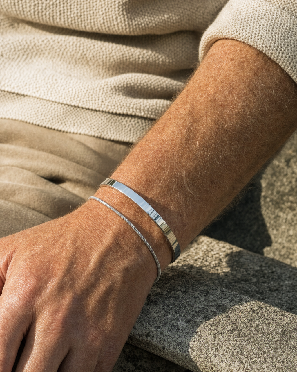 Meridian Cuff worn alongside a silver snake chain bracelet