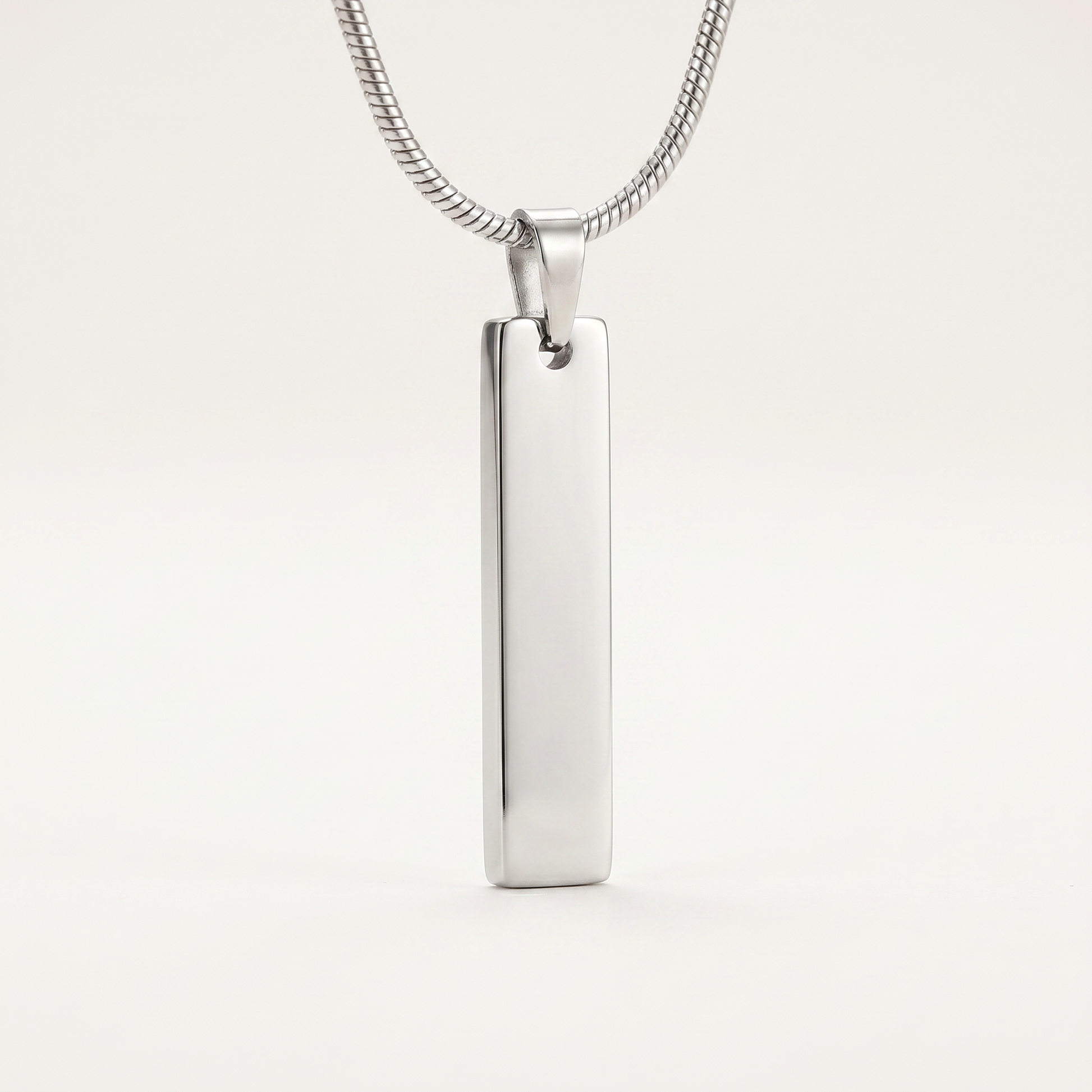 Close-up of the slim silver bar pendant