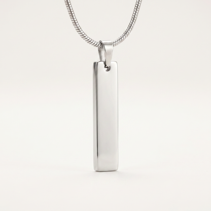 Close-up of the slim silver bar pendant