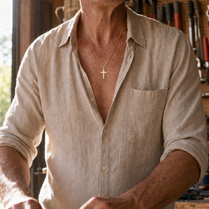 Cross Necklace Gold worn at a workbench