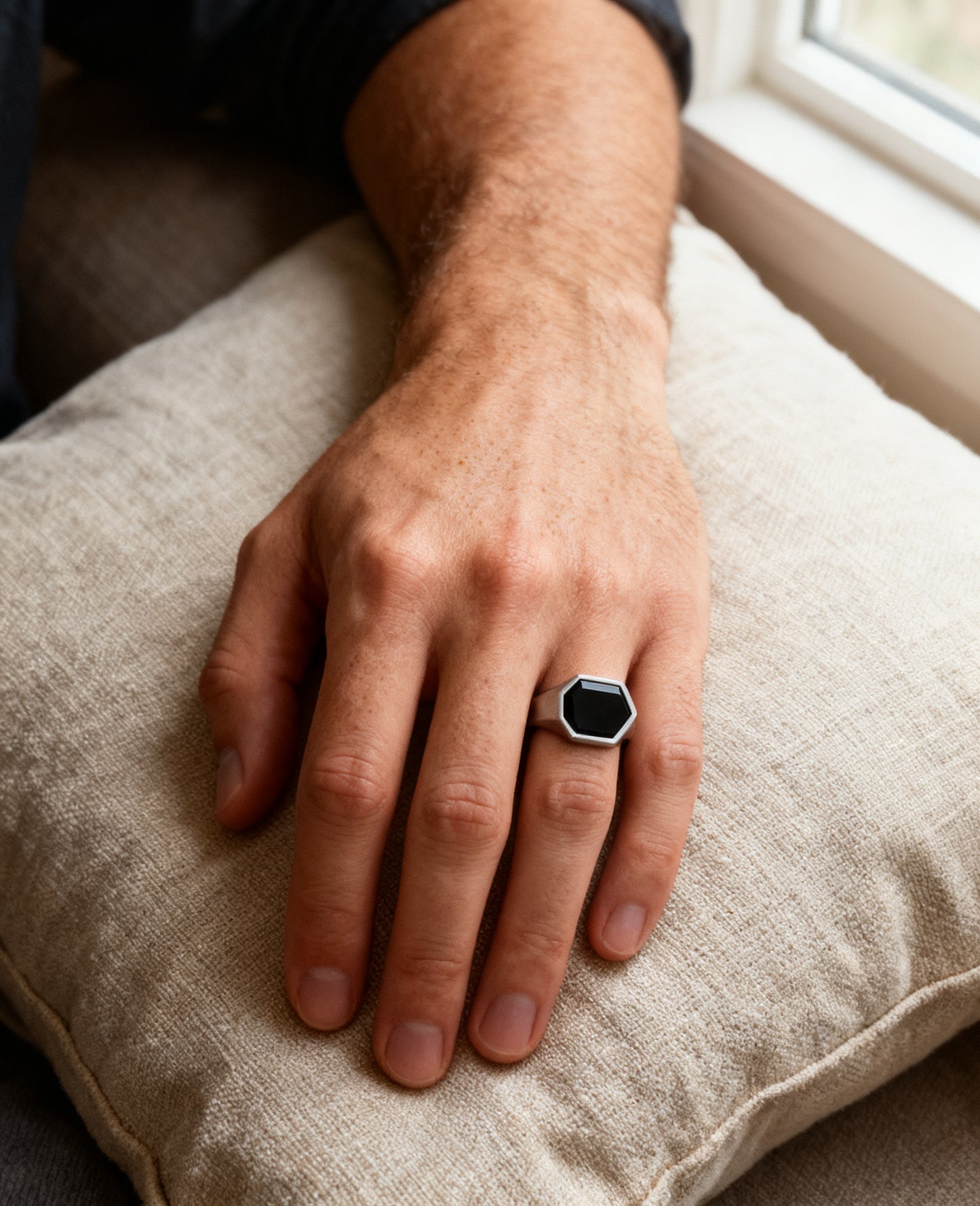 Hexagon onyx signet ring worn on the hand