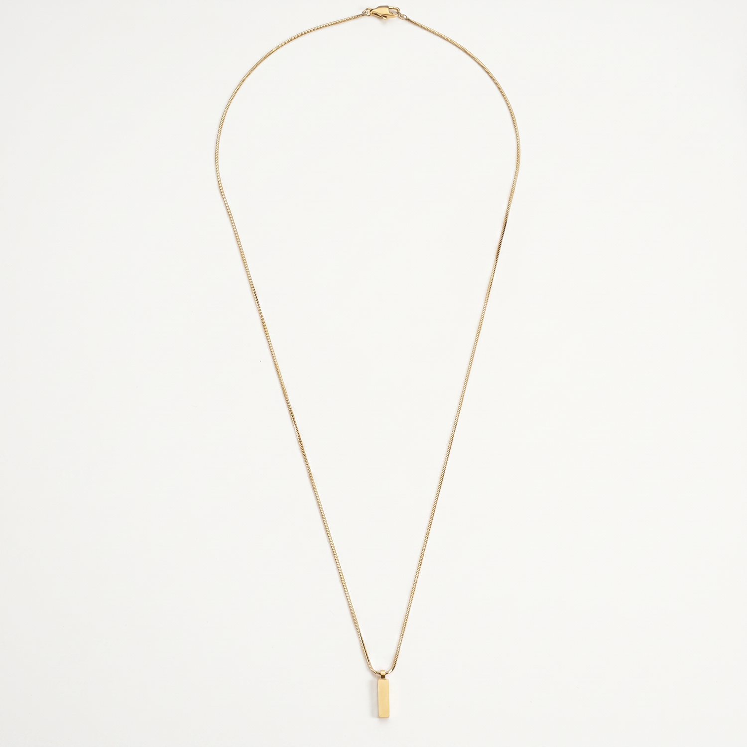 Gold bar pendant necklace on white