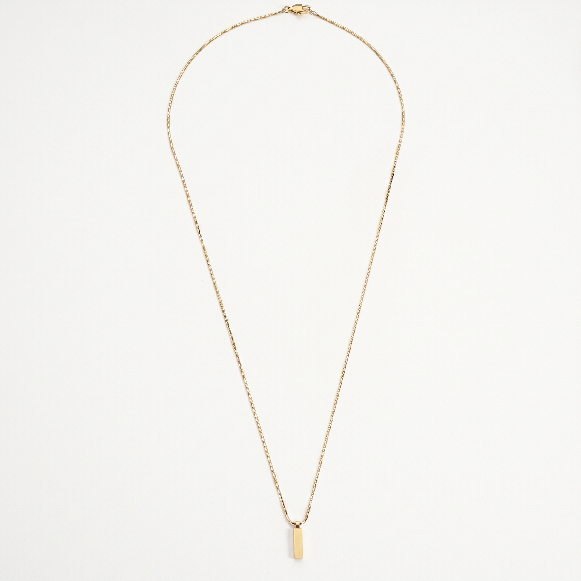 Gold bar pendant necklace on white