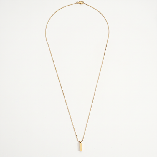 Gold bar pendant necklace on white