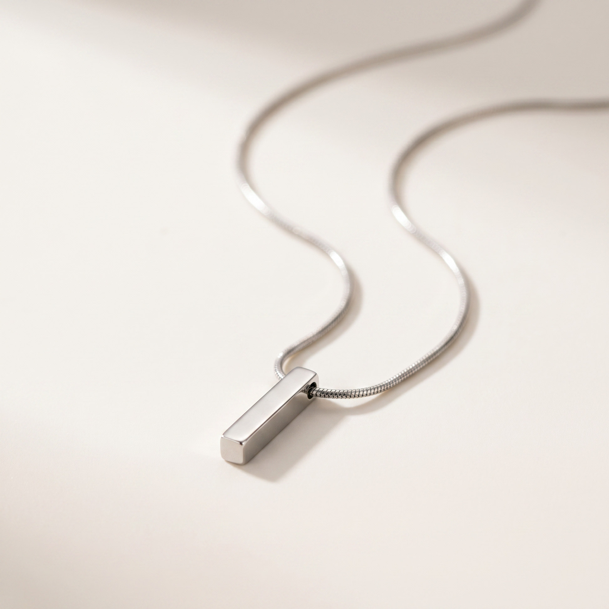 Close-up of the silver bar pendant