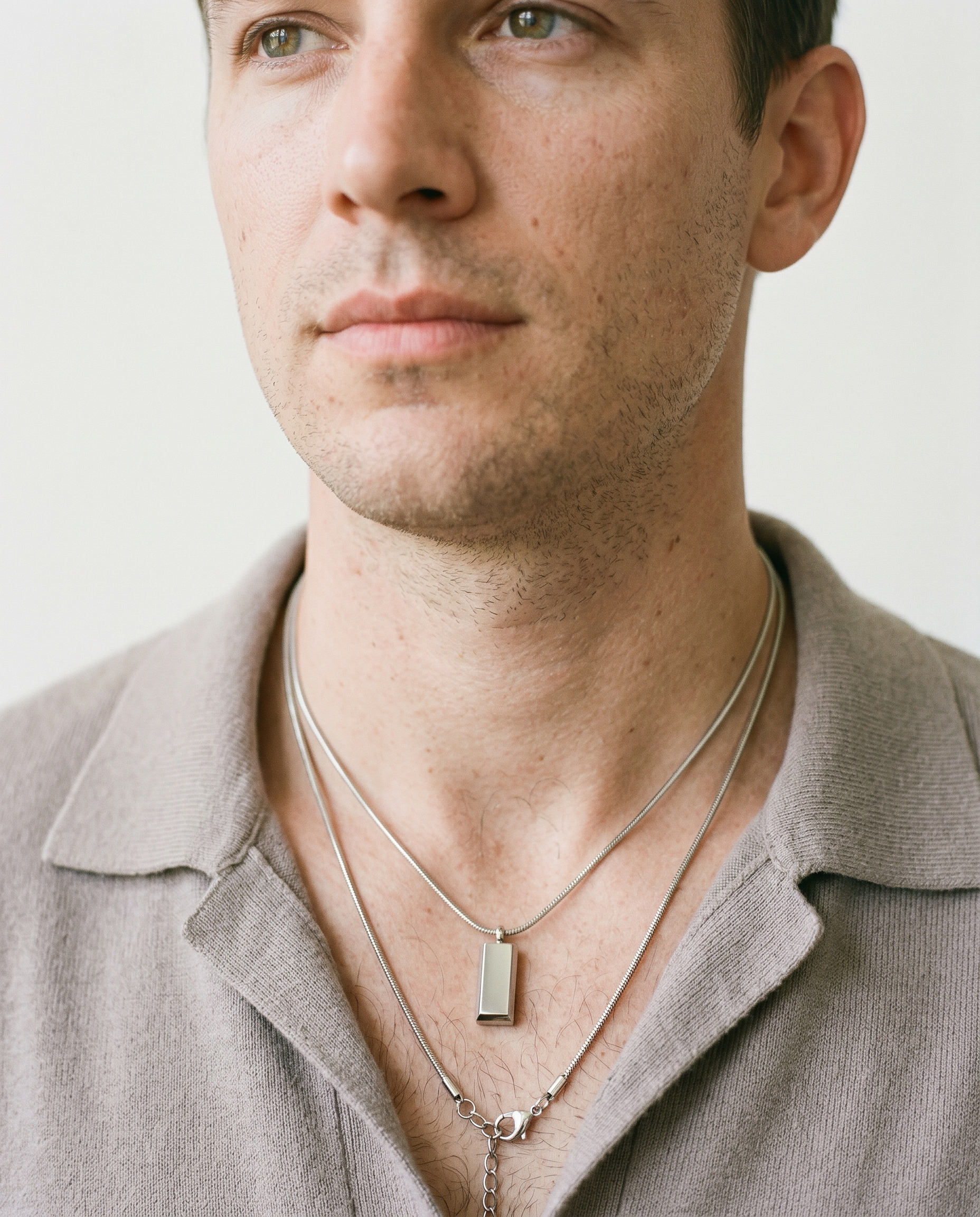 Man wearing the block pendant necklace