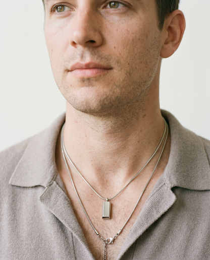 Man wearing the block pendant necklace