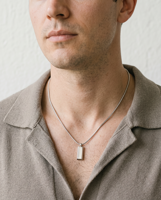 Man wearing the block pendant necklace