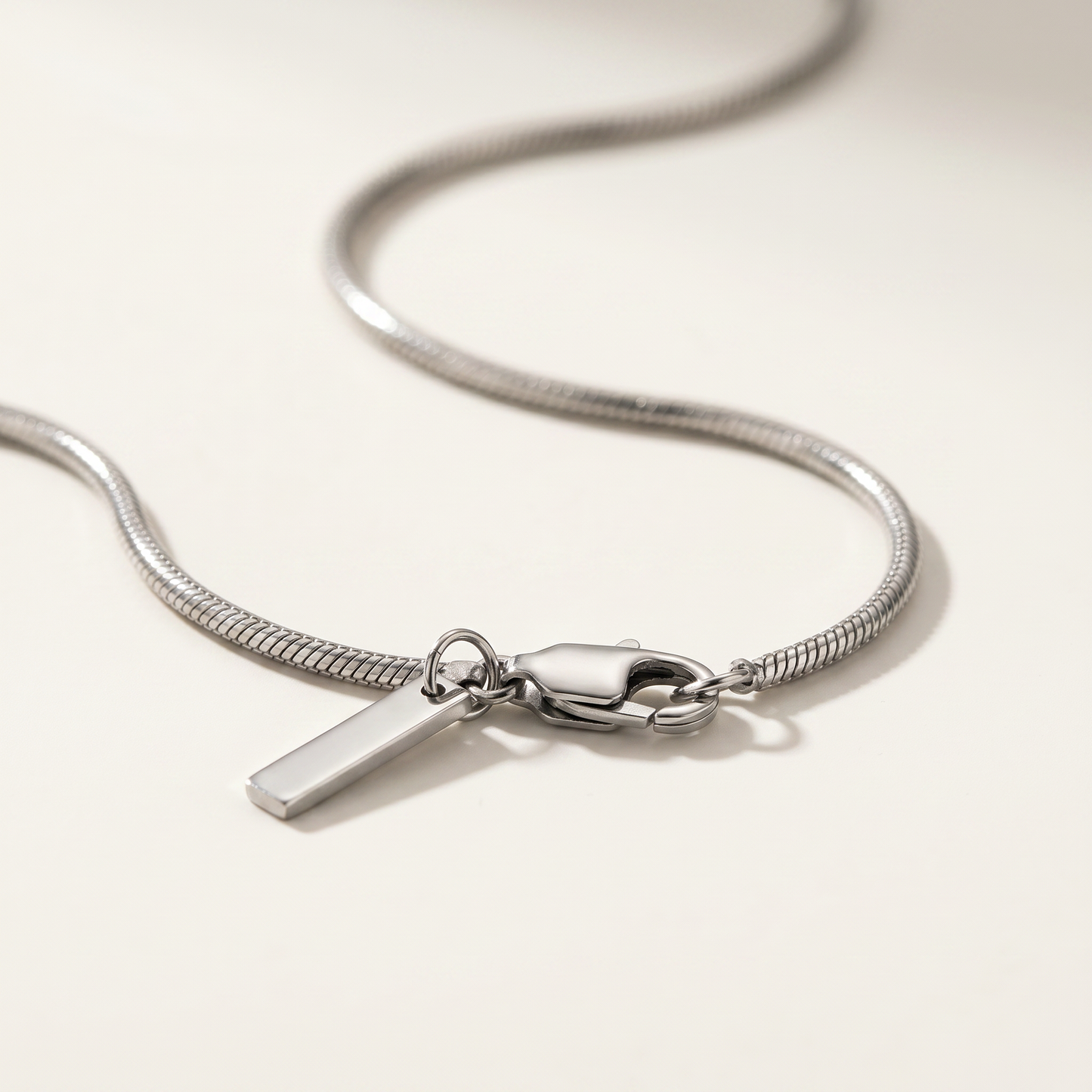 Close-up of the silver chain links and bar tag