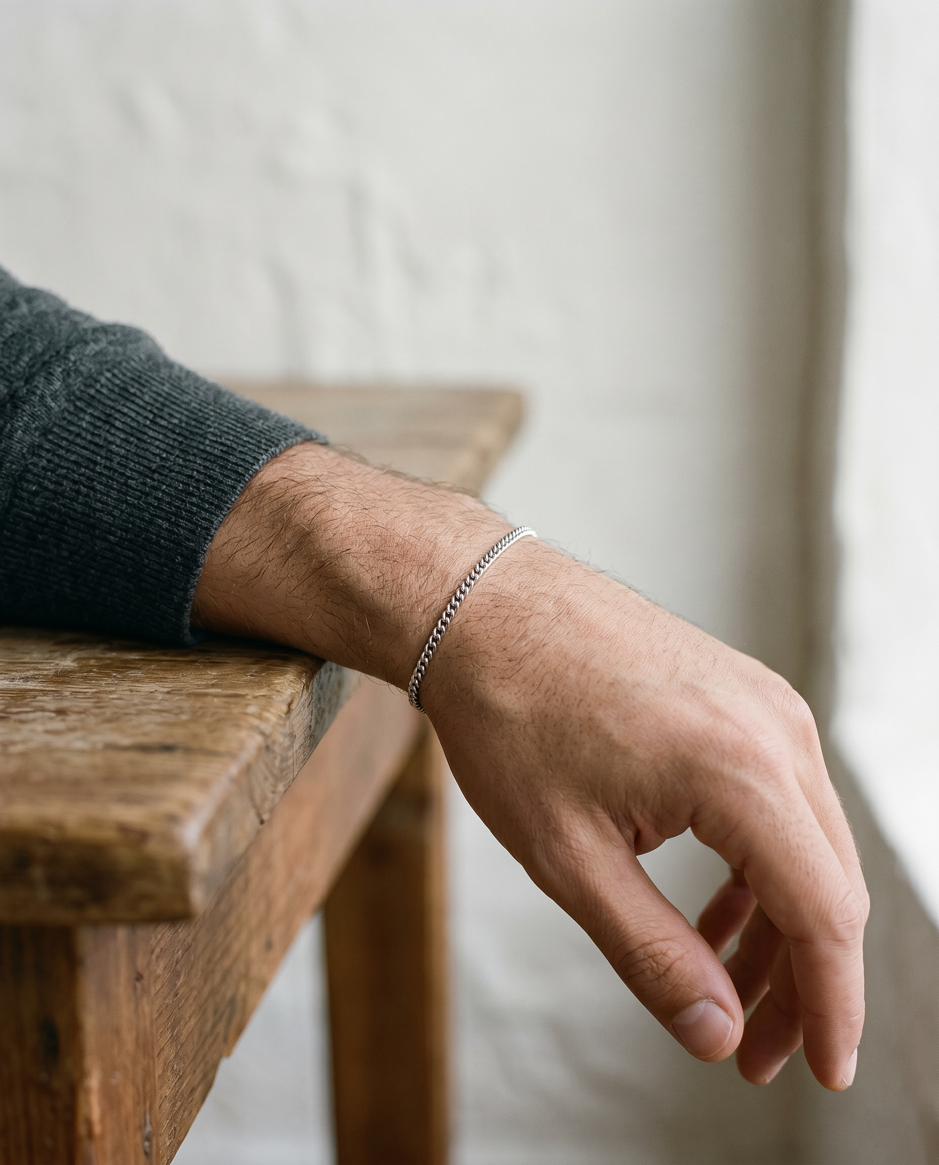 Silver Cuban link bracelet worn on the wrist