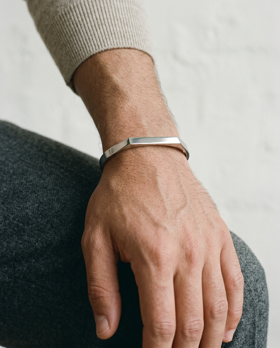 Silver open cuff worn on the wrist