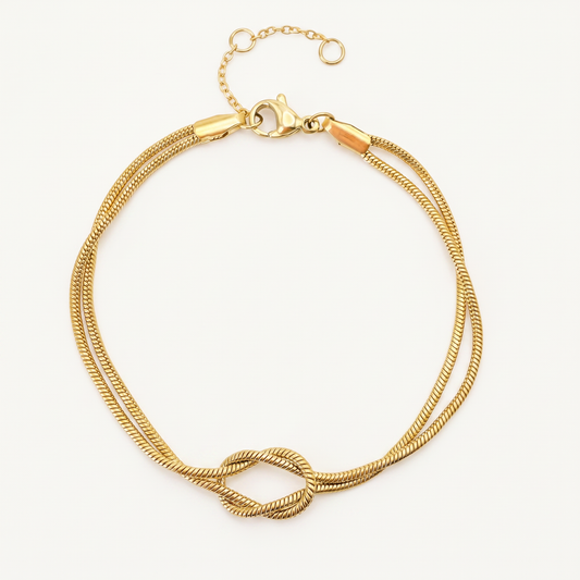 Gold knot bracelet on white