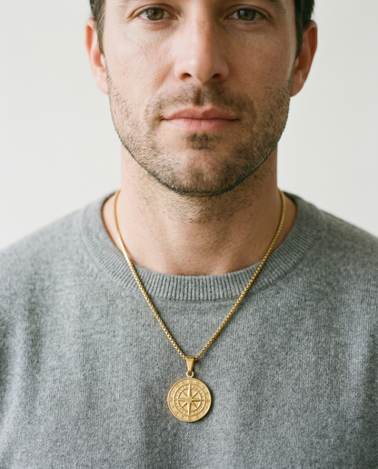 Man wearing the North Star compass pendant on a grey crewneck