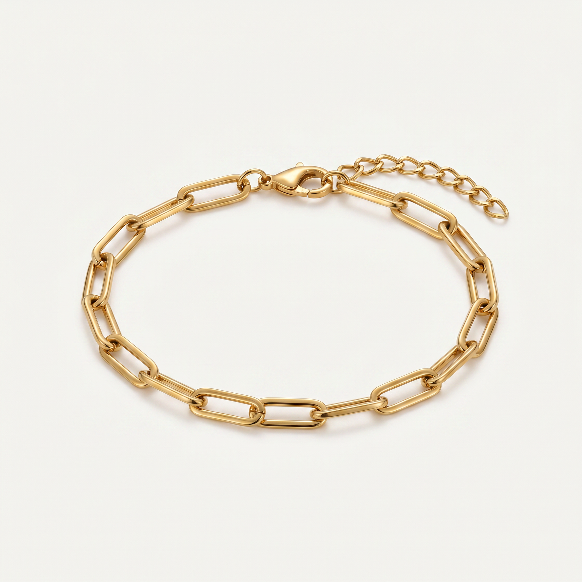 Gold paperclip chain bracelet on white