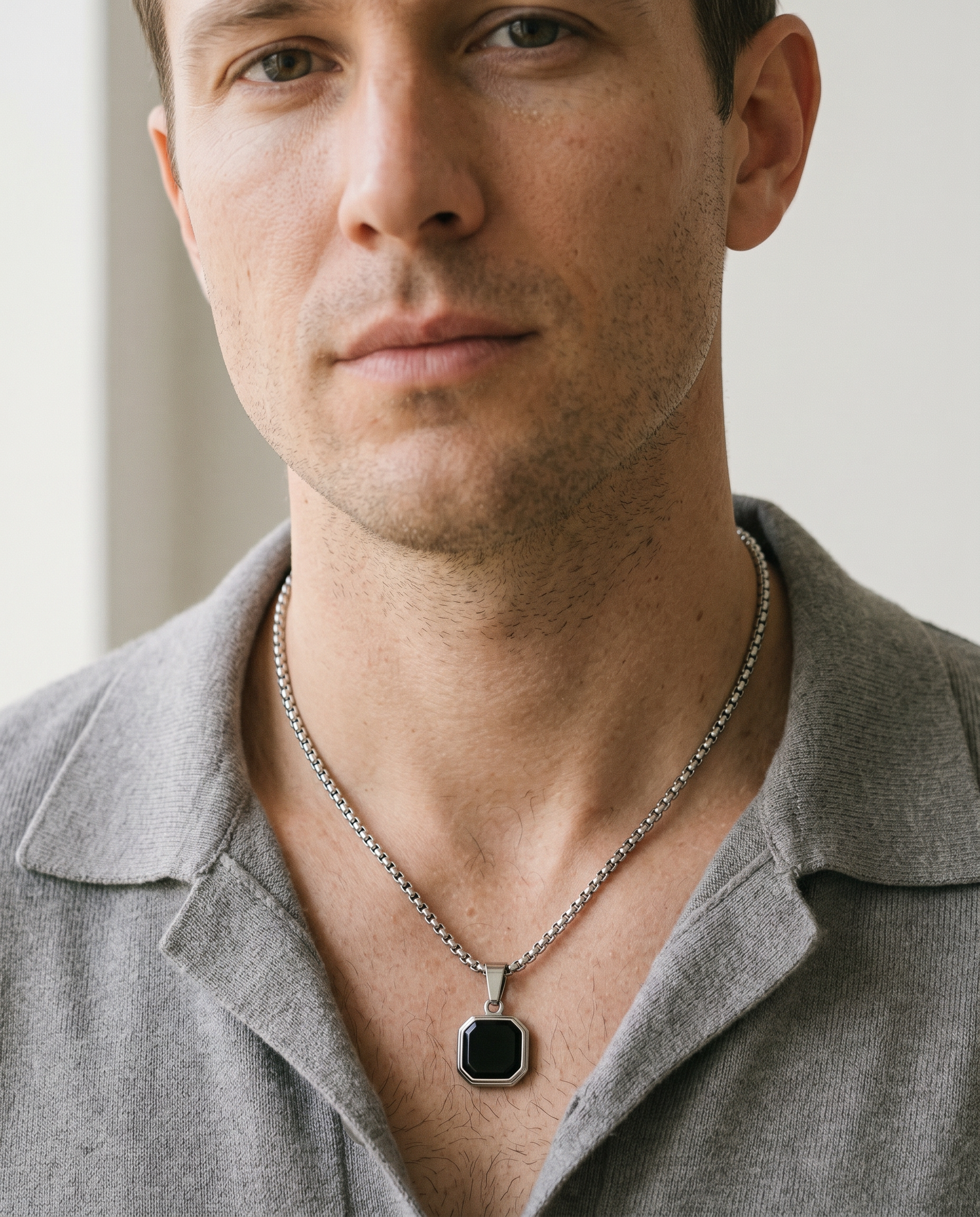 Man wearing the onyx octagon pendant