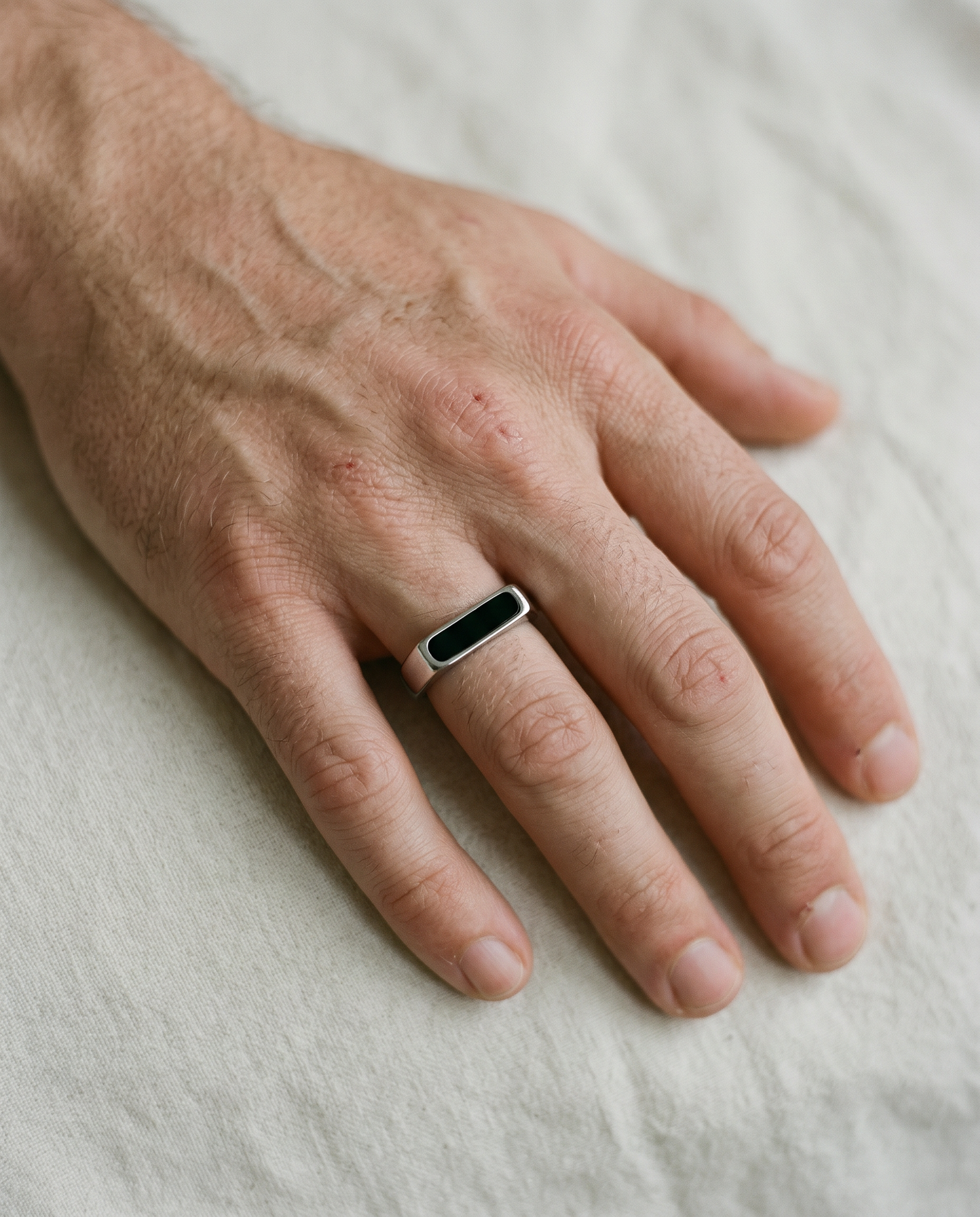 Onyx bar signet ring worn on the hand