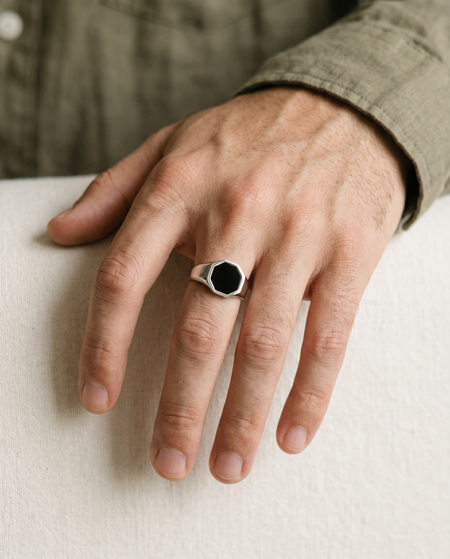 Hexagon onyx signet ring worn on the hand
