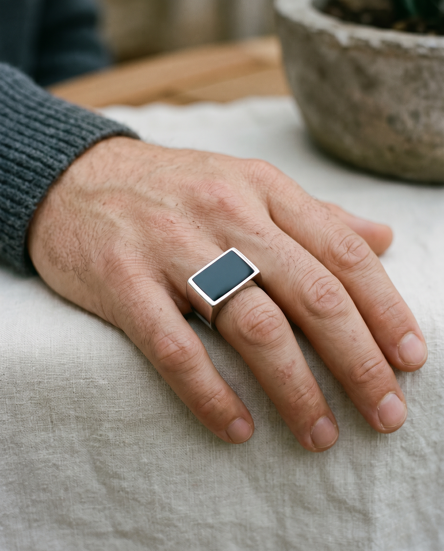 Rectangle onyx signet ring worn on the hand