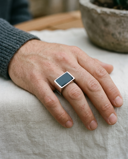 Rectangle onyx signet ring worn on the hand