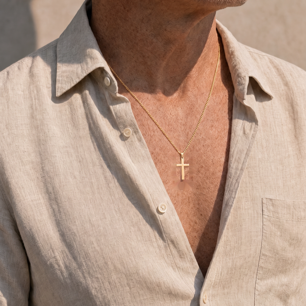 Cross Necklace Gold worn at an open shirt collar