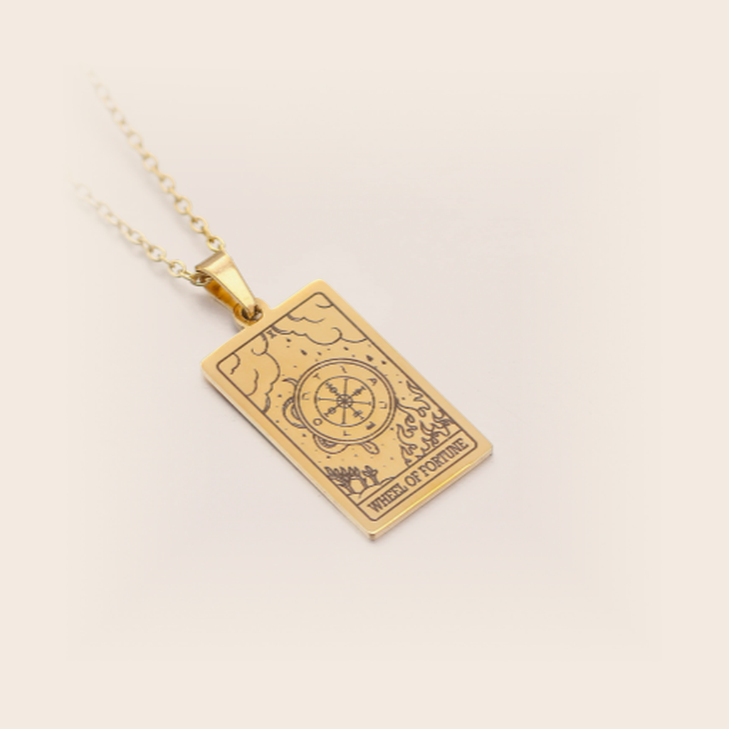 Tarot Necklace Gold, Wheel of Fortune, studio packshot on cream